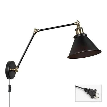 Black industrial-style DecorBites™ wall sconce with adjustable arms, brass accents, and plug-in design for commercial space