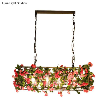 Rectangular pendant light with dark metal construction, hanging chains, pink artificial roses, ideal for bedroom fixture height