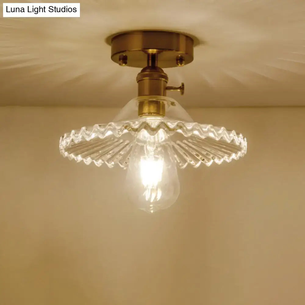 DecorBites™ one-light ceiling light with vintage brass finish and clear scalloped ribbed glass shade
