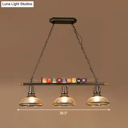 Industrial style billiard light pendant with dark metal frame brass accents and chain cord length for restaurant island