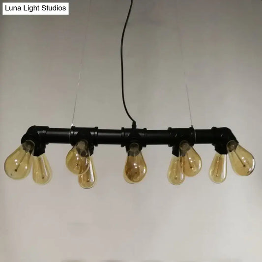 Industrial style ceiling light fixture featuring black metal piping and five amber glass filament bulbs for dining room use