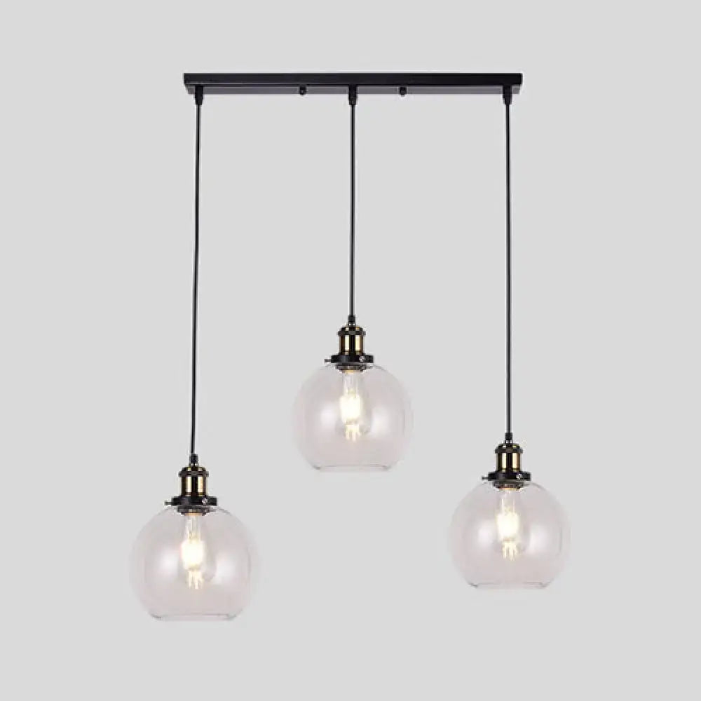 Black metal industrial style brass pendant light kit with three clear glass globe round barn admix hanging lamps