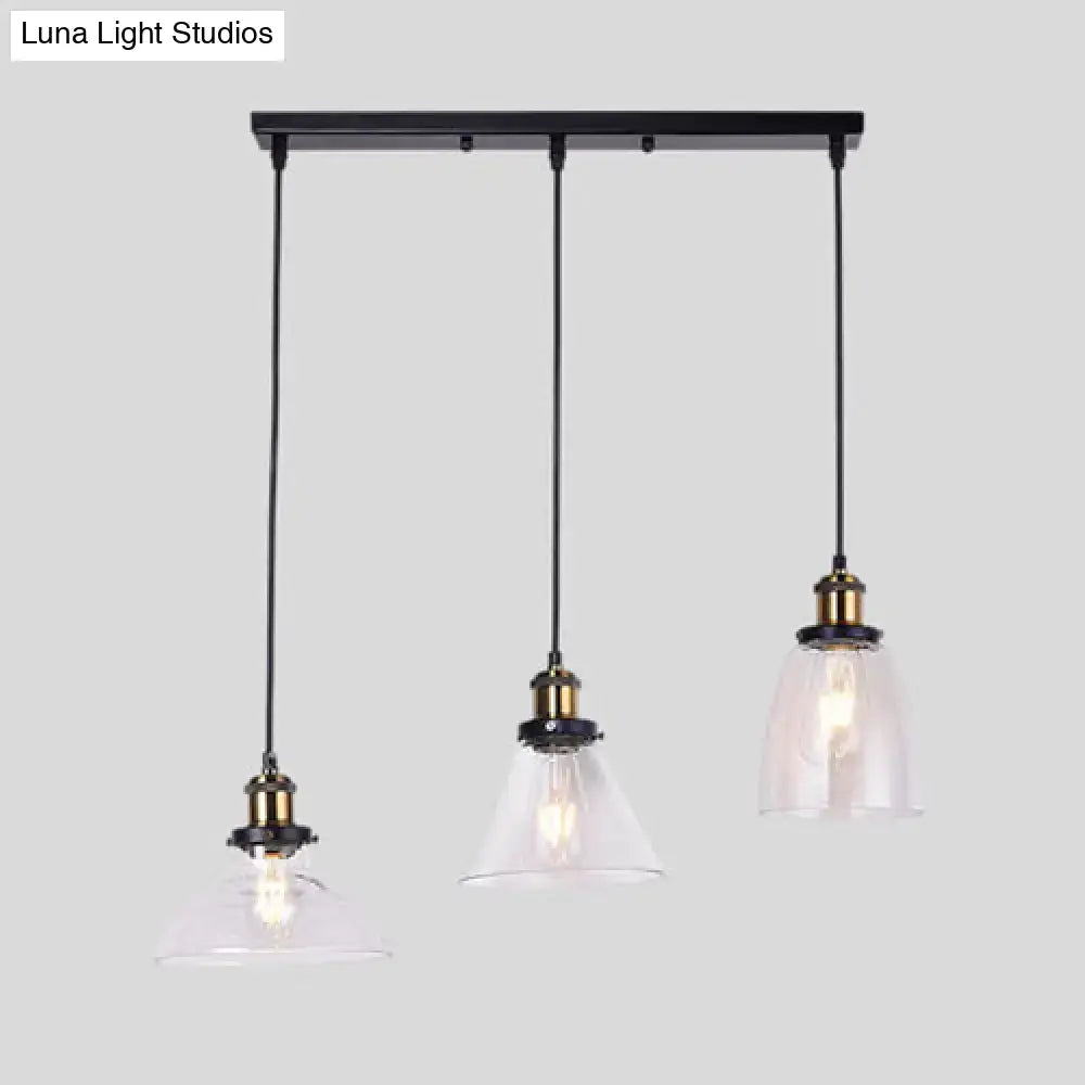 Black metal bar with three clear glass pendant lights featuring industrial style brass sockets in round barn admix design