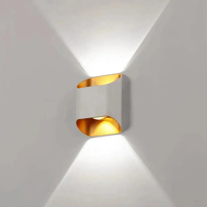 Modern DecorBites™ IP65 led outdoor wall lights with sleek white body and gold accents casting warm directional light