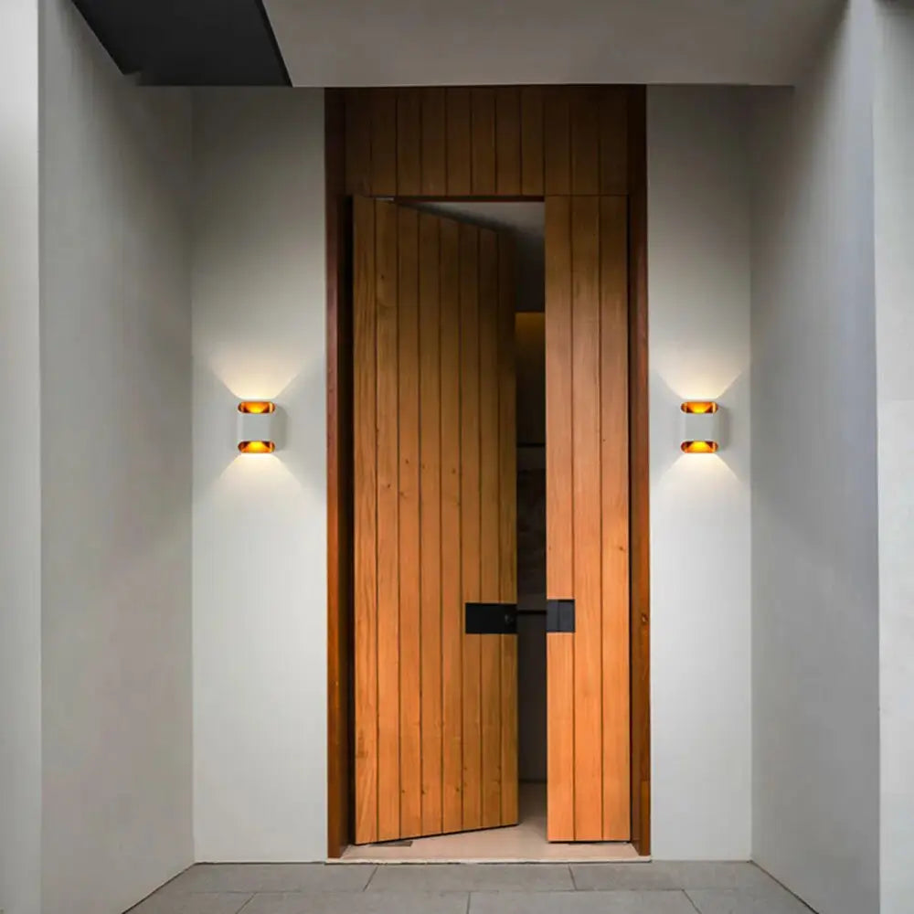 Warm-toned wooden slat door with sleek black hardware complementing decorbites modern led outdoor wall lights