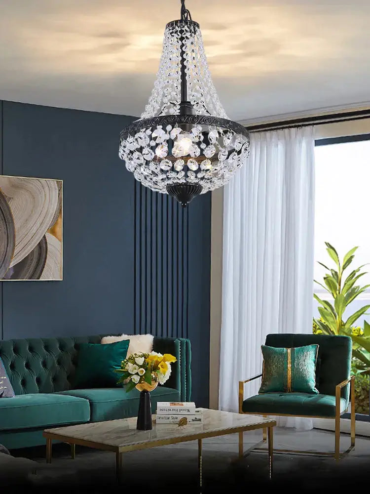 A decorbites iron art crystal chandelier with black metal frame hanging in a dining room ceiling light fixture