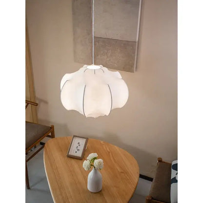 A soft white petal-shaped pendant light with subtle black outline from decorbites italian silk pendant lights collection