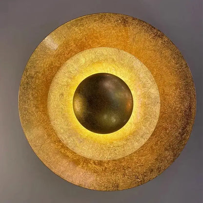 Golden textured circular wall sconce with concentric rings and central glowing orb decorbites italian vintage art