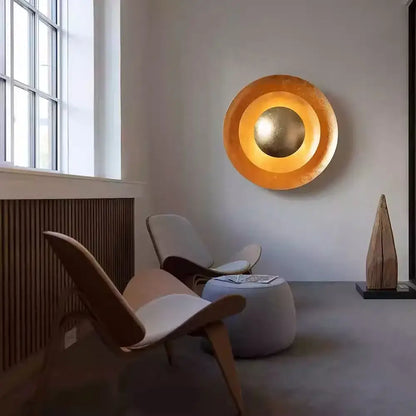 Golden circular wall sconce with concentric rings and reflective center by Decorbites italian vintage for living room