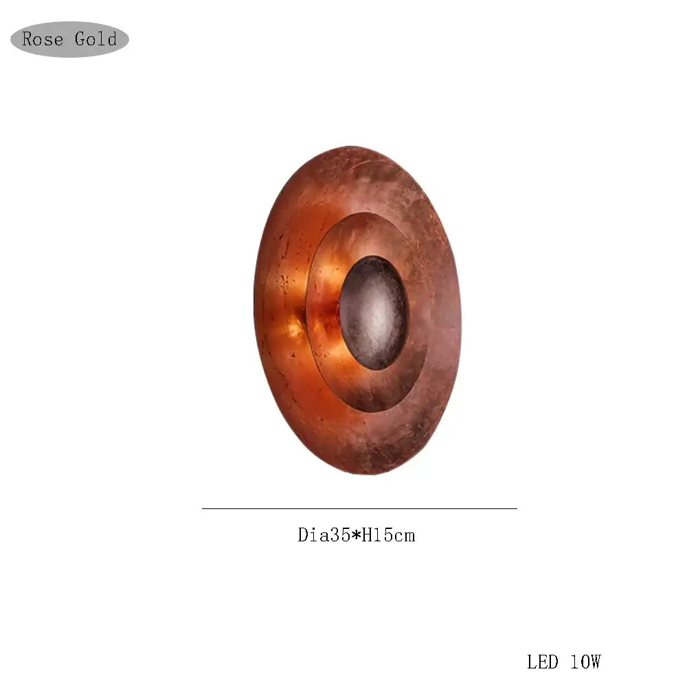 Rose gold oval wall sconce with concentric circular design and led lighting by Decorbites italian vintage for living room