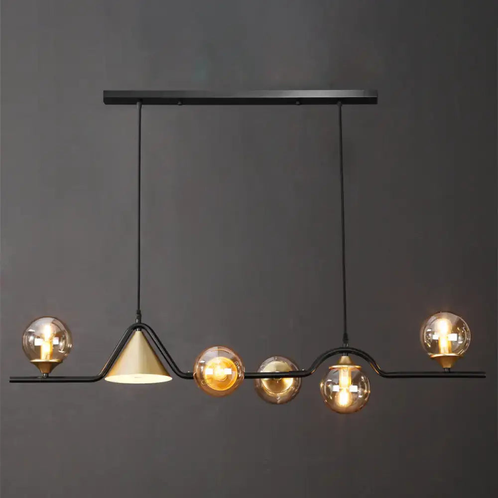 Black metal chandelier with five spherical glass bulbs and one conical brass shade for ivory glass island pendant lighting