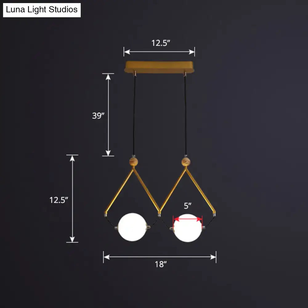 DecorBites™ ivory glass minimalist ball suspension light with gold-toned geometric frame and black cords for restaurant suspension light