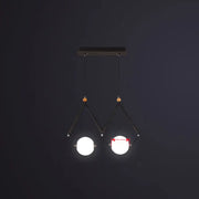 Modern black metal suspension light with two glowing ivory glass spheres in minimalist ball restaurant suspension design