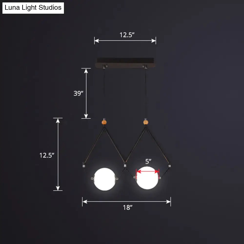 Modern black metal DecorBites™ suspension light with two glowing ivory glass balls and wooden accents for restaurant lighting