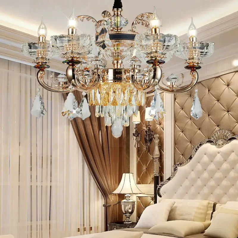 A luxurious gold-toned decorbites jade crystal chandelier with intricate detailing and dangling teardrop crystals