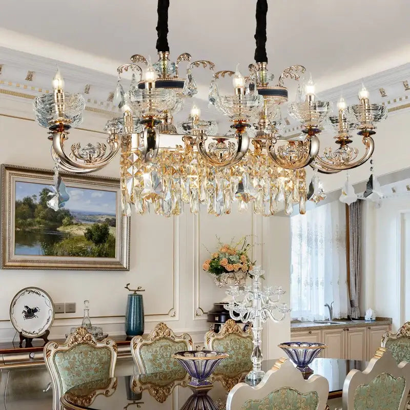 An ornate gold and crystal decorbites jade crystal chandelier with multiple arms hanging above a dining table