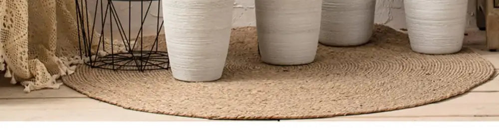 Beige round jute rug with textured woven surface shown with decorbites™ japanese minimalist hydroponic vase set
