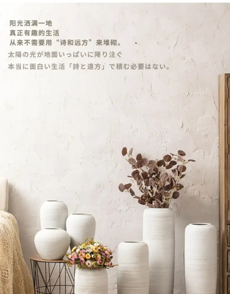 A collection of white ceramic minimalist hydroponic vases with textured surfaces in varying heights and shapes by decorbites