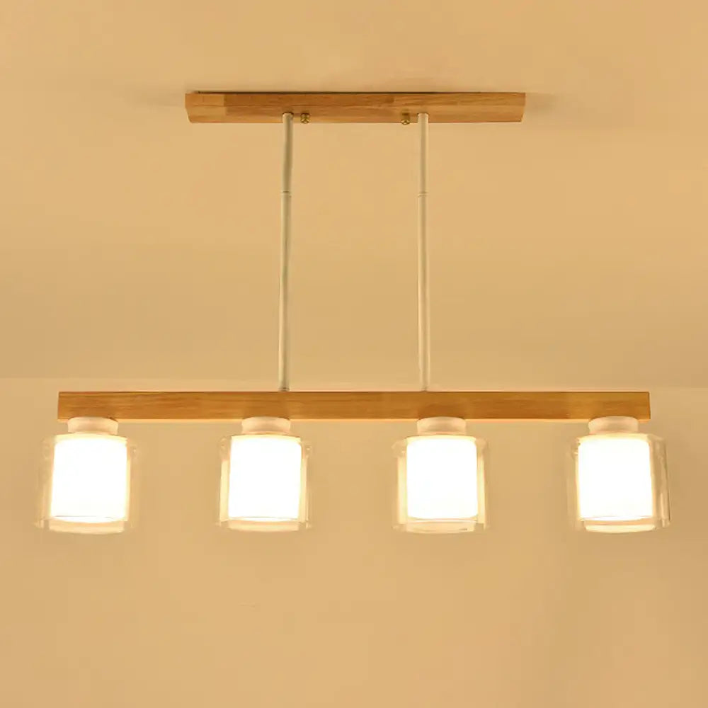 Minimalist DecorBites™ white glass cylinder LED island pendant light with four frosted shades for dining room ceiling