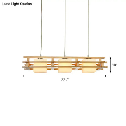 Modern wooden pendant light with three warm-toned blown glass shades, minimalist design ideal for cube restaurant islands
