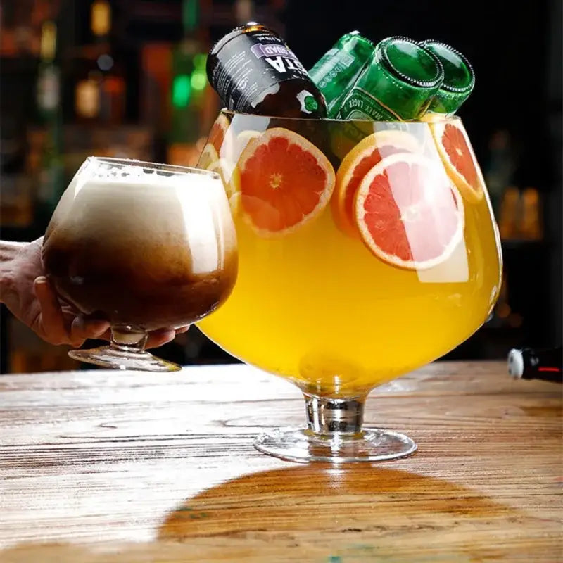 A decorbites jumbo party large capacity clear glass goblet filled with orange liquid and grapefruit slices