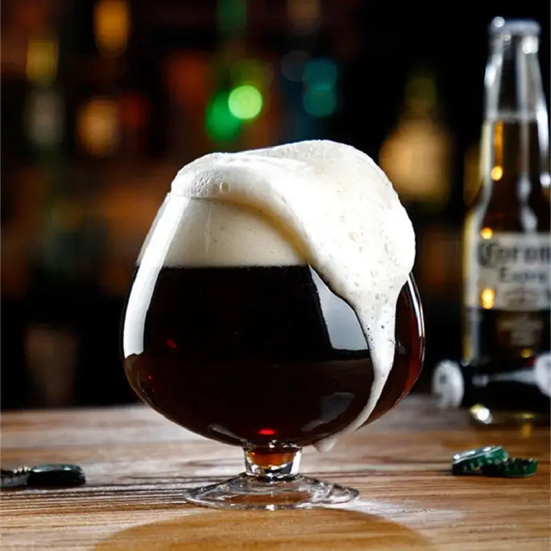 A dark amber beer fills a clear decorbites jumbo party glass with large capacity and creamy foam topping