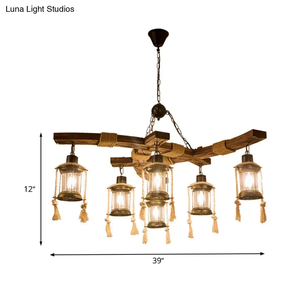 Rustic wooden chandelier with five lantern-style clear glass lights and brass metal frame with beige tassels for led incandescent use