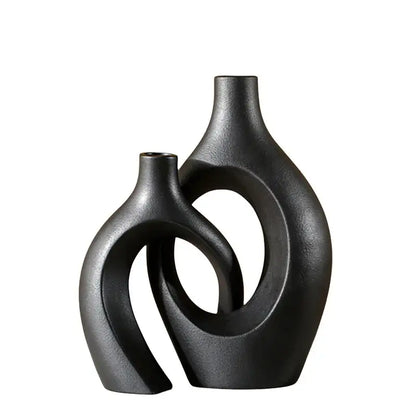 Two interlocking black matte ceramic vases with smooth curved surfaces large 21cm for home decor by DecorBites™