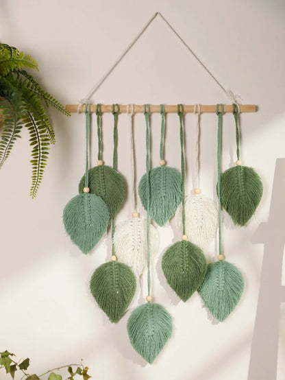 DecorBites™ macrame wall hanging with green and white woven leaves on brown wooden rod for boho home decor