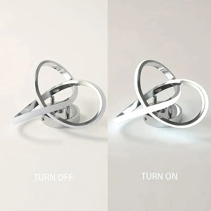 Modern chrome finished decorbites led ceiling wall sconce with intertwined ring design glowing softly for living rooms