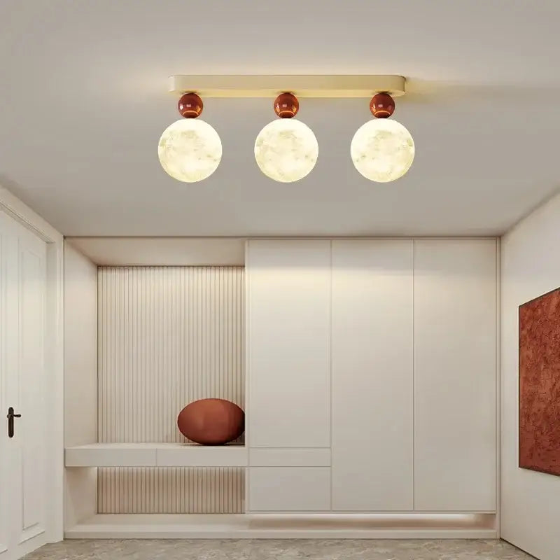 Modern three-light decorbites led ceiling moon fixture with frosted glass globes and copper-toned accents for bedroom lighting