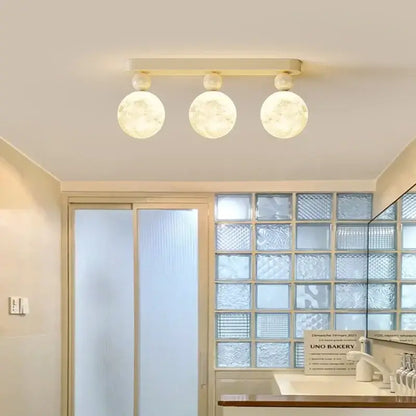 Modern decorbites led ceiling fixture with three frosted glass globes and matte cream metal bar for bedroom lighting