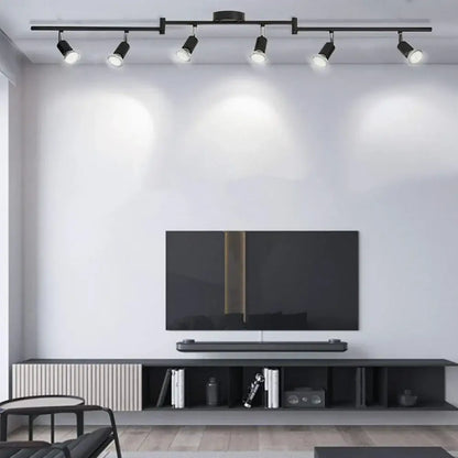 Black decorbites™ led ceiling spotlight chandelier with five adjustable spotlights mounted above a television