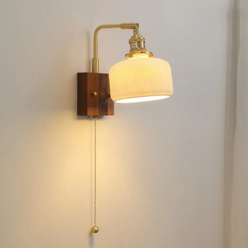 Brass-finished decorbites led ceramic wall sconce with ribbed off-white glass shade and wooden base light fixture