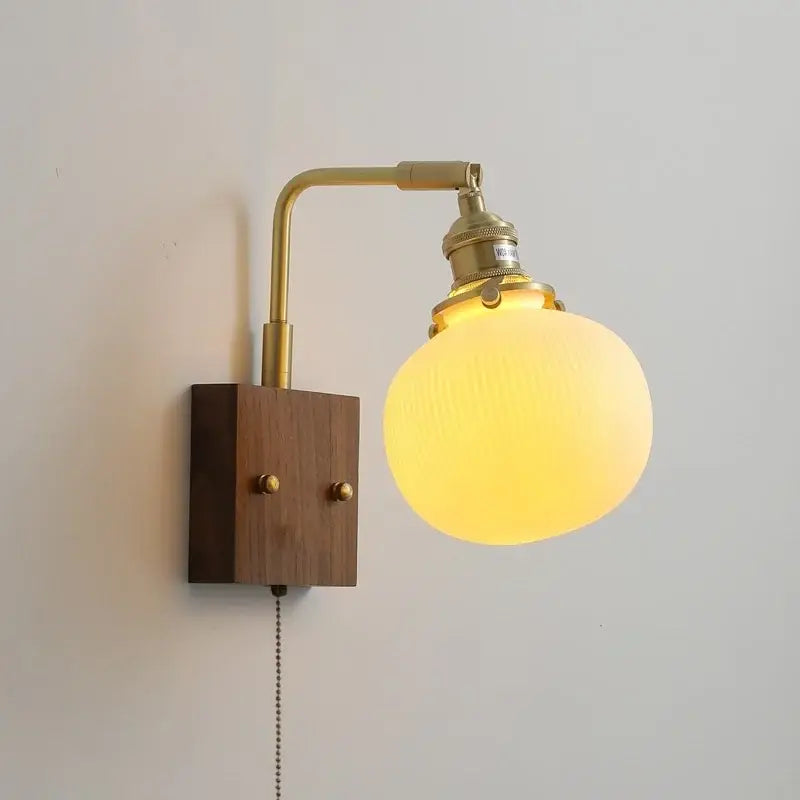 Brass-finished decorbites led ceramic wall sconce with warm frosted glass globe and wooden base light fixture with pull chain switch