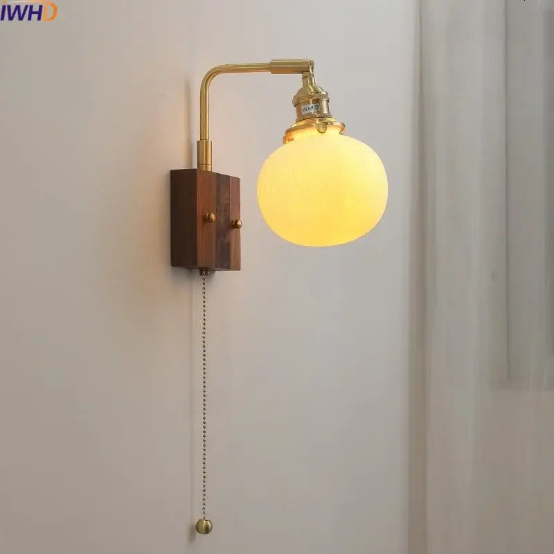 Brass-finished decorbites led ceramic wall sconce light fixture with wooden base and frosted glass globe shade