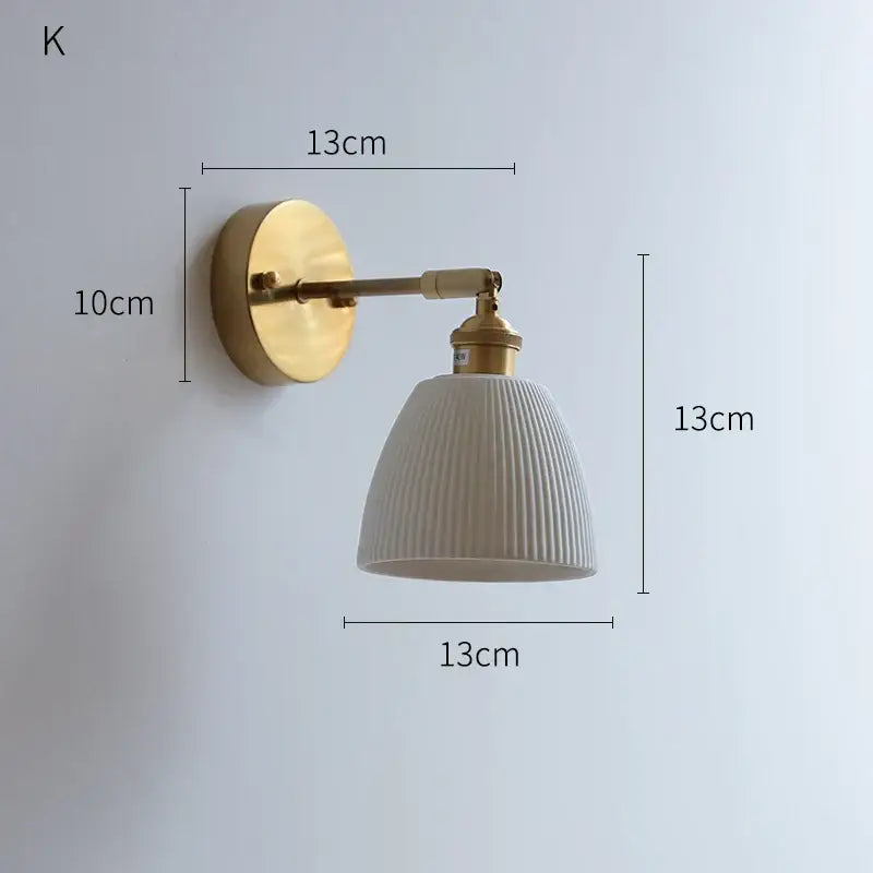 Vintage-style wall sconce with brass metal arm and off-white ribbed ceramic shade decorbites led ceramic wall lighting