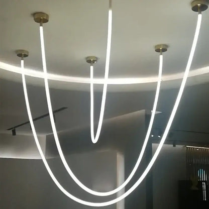 Modern minimalist pendant light with five glowing white led strips and brass-finished mounts by DecorBites LED chandelier