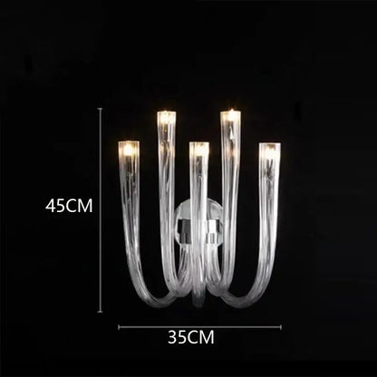 Clear glass decorbites led chandelier lighting fixture with five curved arms and warm glowing lights for bedroom ceiling