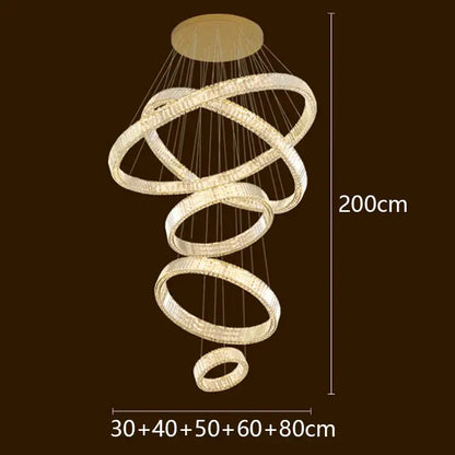 A modern spiral-shaped DecorBites LED chandelier with glowing crystal-encrusted metal rings for elegant lighting