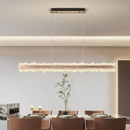 A decorbites led chandelier with a rose gold frame and cascading crystals, suspended from a black ceiling mount