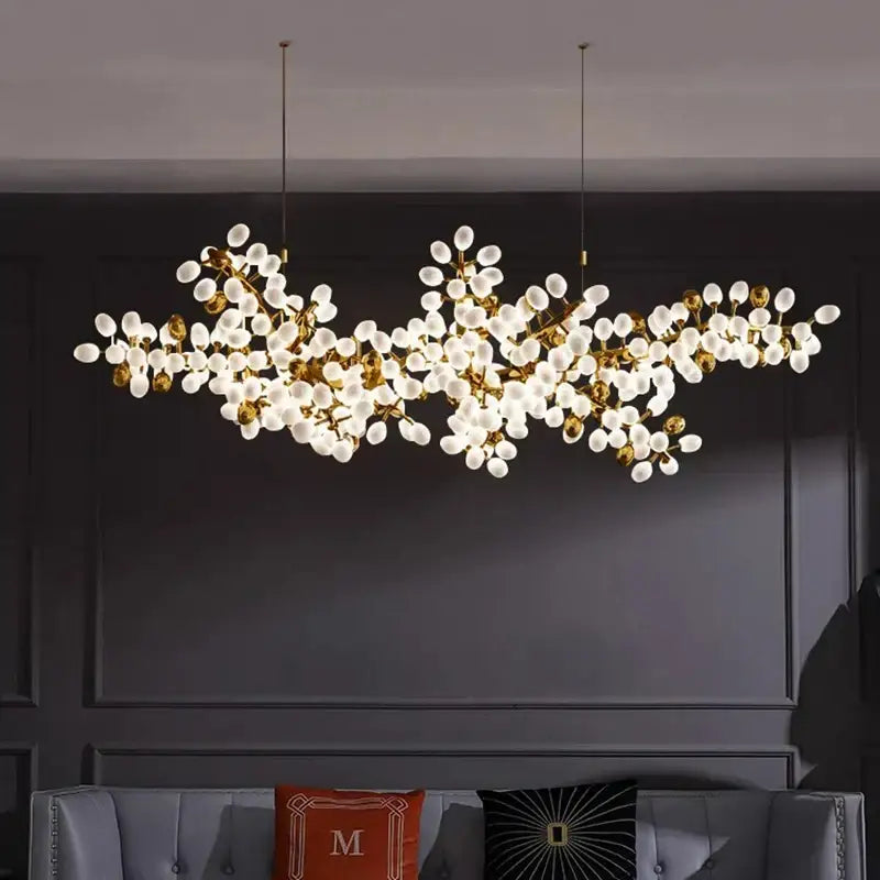 Gold-toned DecorBites LED chandelier lighting with frosted glass globes resembling blossoms for living room and bedroom