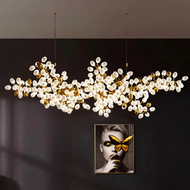 Gold-toned decorbites led chandelier lighting with frosted glass orbs resembling blossoms for living and dining rooms