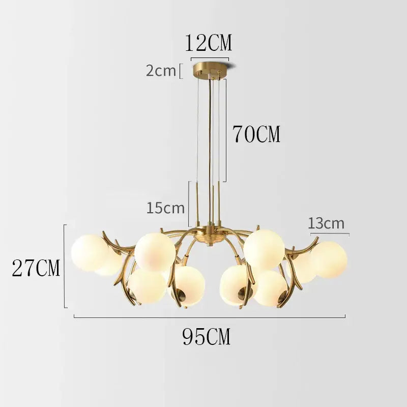 Gold-toned decorbites led chandelier with frosted glass globes in a branching design for modern living and dining rooms