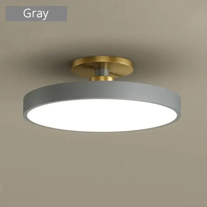 Gray circular led chandelier light with brass-colored mounting base for modern indoor home living decorbites