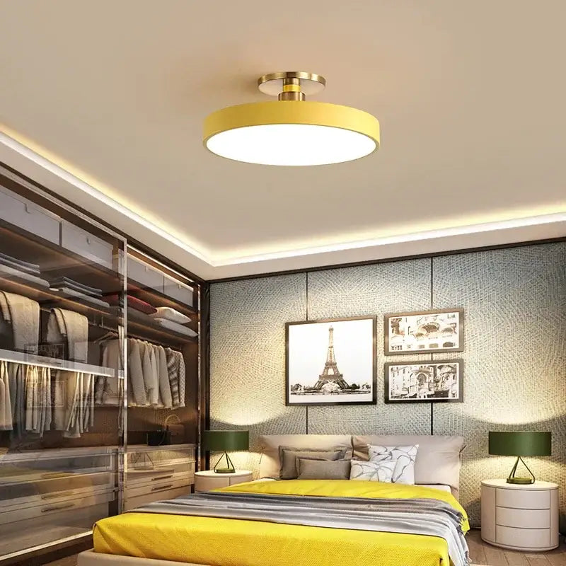 Yellow circular led chandelier light with brass-colored central fixture for modern indoor home and bedroom lighting