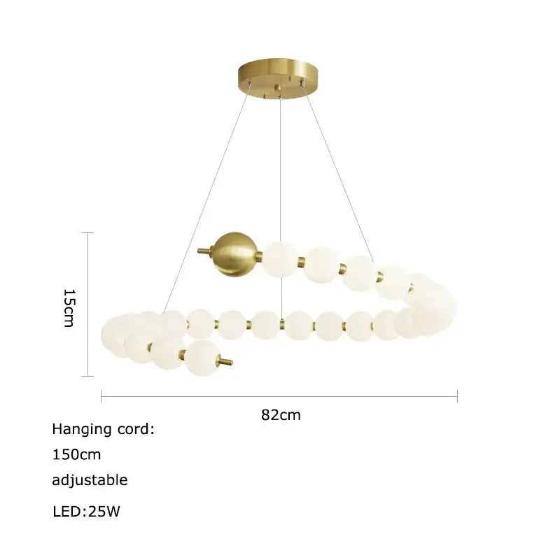 A modern decorbites led chandelier with brass metal frame and frosted glass spheres in a spiral for dining room lighting