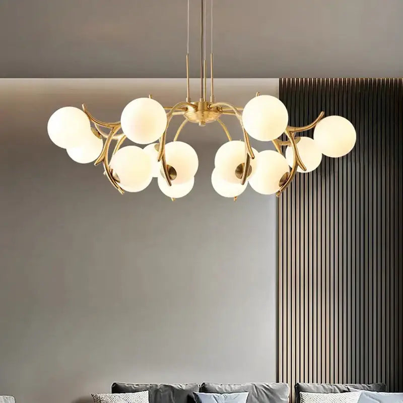 Gold-toned decorbites led chandelier pendant lamp with frosted glass globe bulbs in a branching design for living spaces
