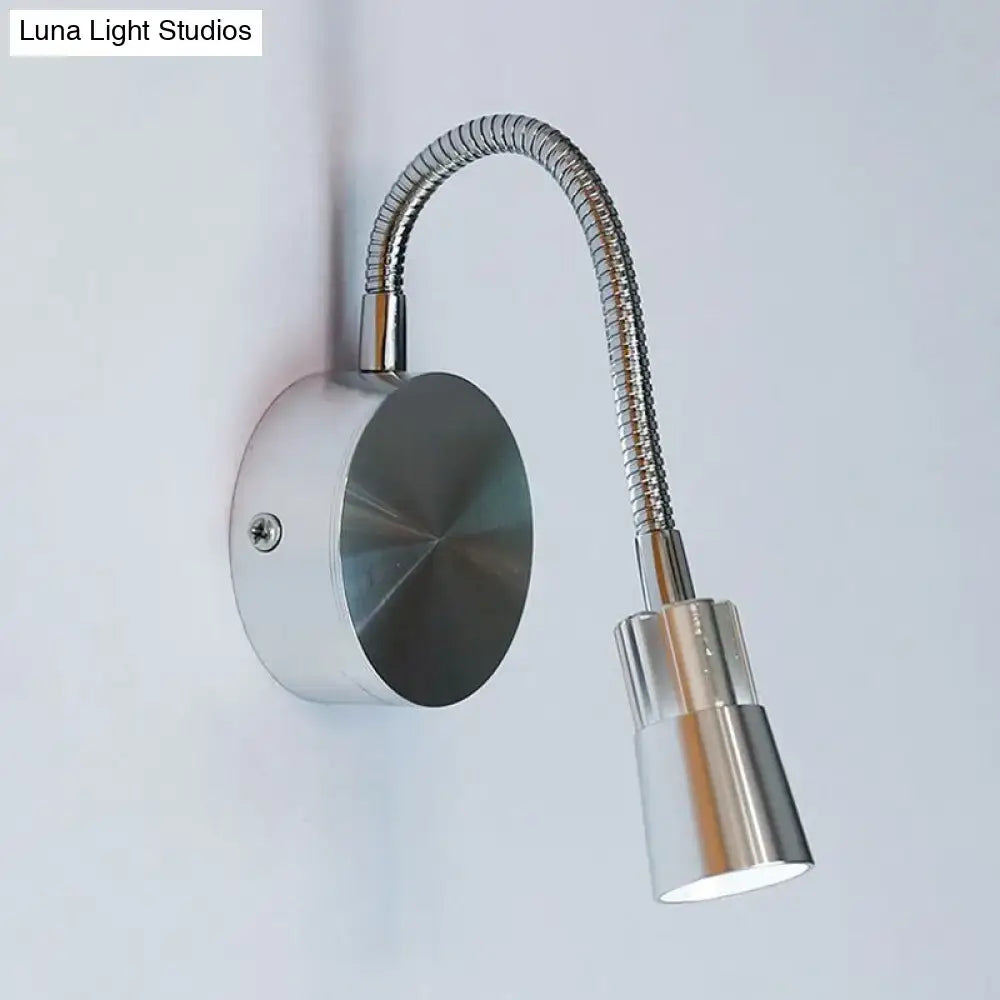 Silver metallic wall-mounted reading lamp with flexible gooseneck and adjustable mini metal shade for bedroom use