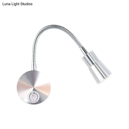 Silver metallic gooseneck reading lamp with chrome flexible arm and mini metal shade for bedroom use